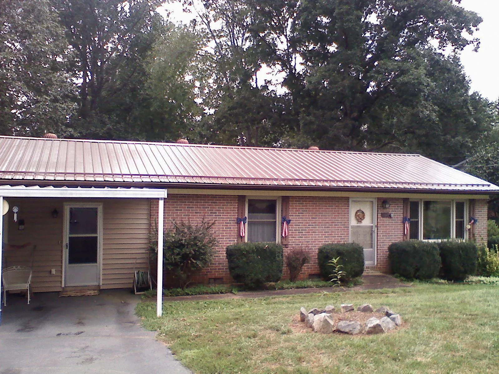 Bronze metal roof and carport on a brick ranch home — Roof Repair work by our crew in Bellingham